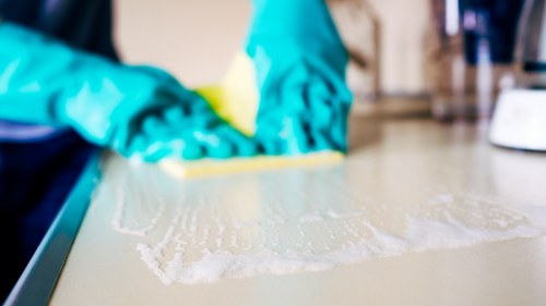 Deep cleaning a sectional sofa with professional equipment